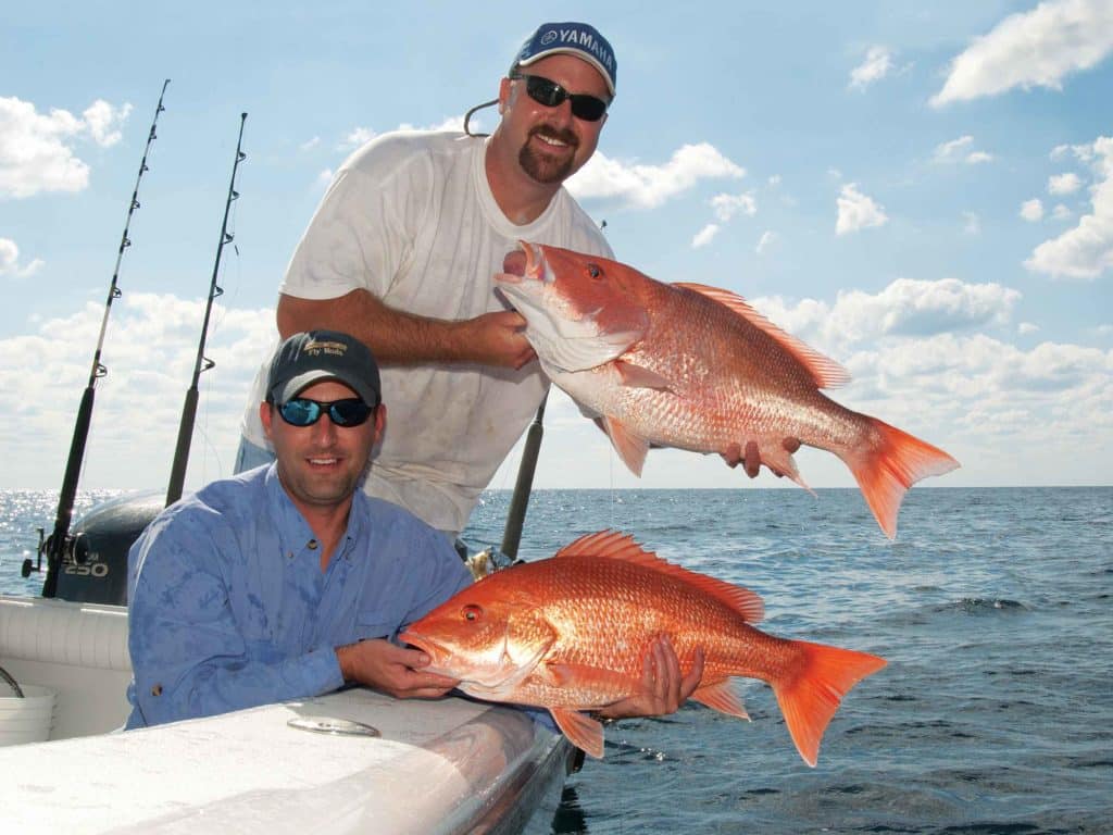anglers hold up red snapper fish Gulf of Mexico fishing