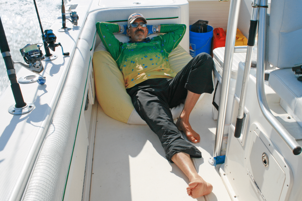 Angler laying on a beanbag in a center console fishing boat