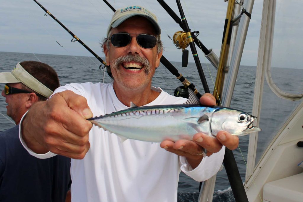 John Graves displays an adult bullet tuna taken while sampling for juvenile bluefin tuna off Virginia.