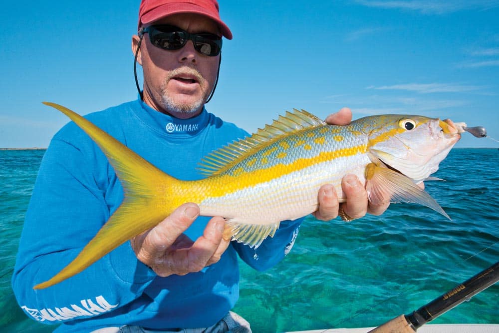 Angler holding Florida Keys yellowtail fish caught fishing