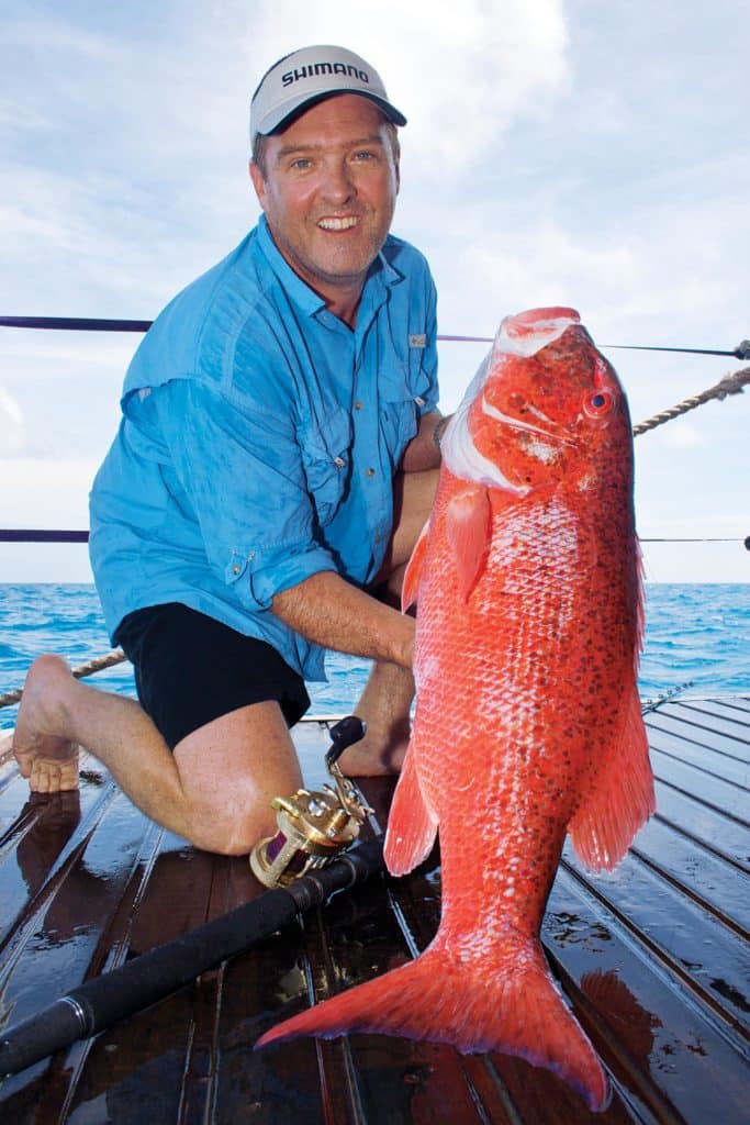 Fisherman holding a Chinaman fish snapper) from Australia