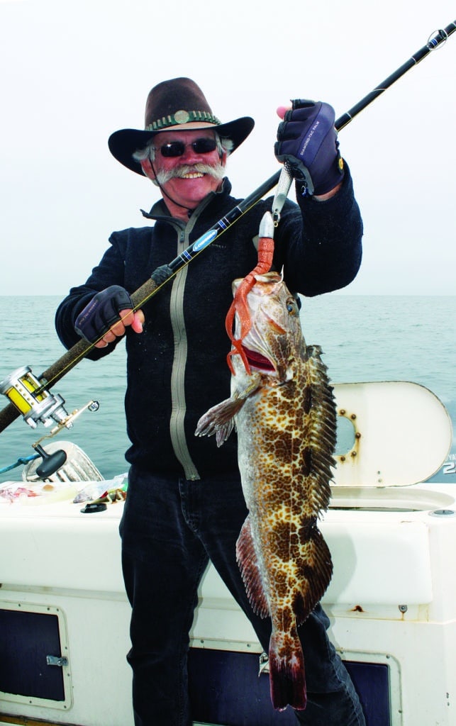 Angler holding lingcod caught fishing Channel Islands