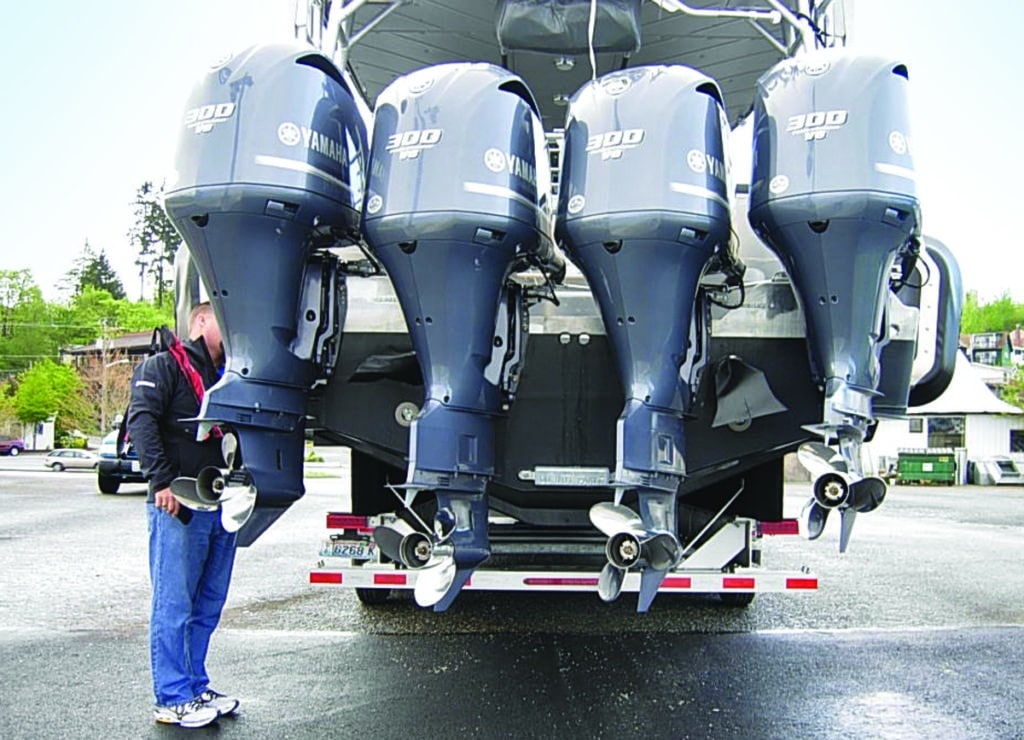 Quad Yamaha outboards on a fishing trailered boat at the ramp