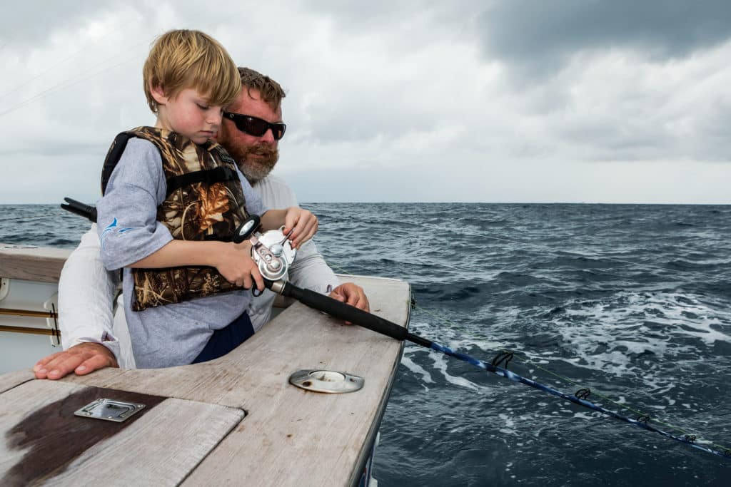 Young kid fishing offshore