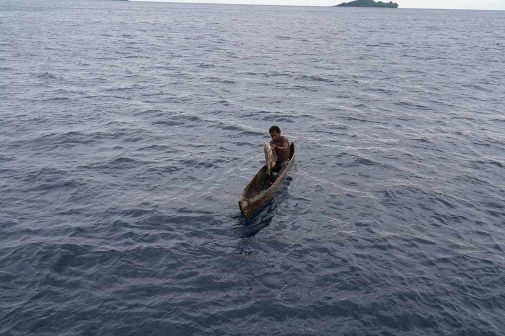 Local tribesman with an emperor fish