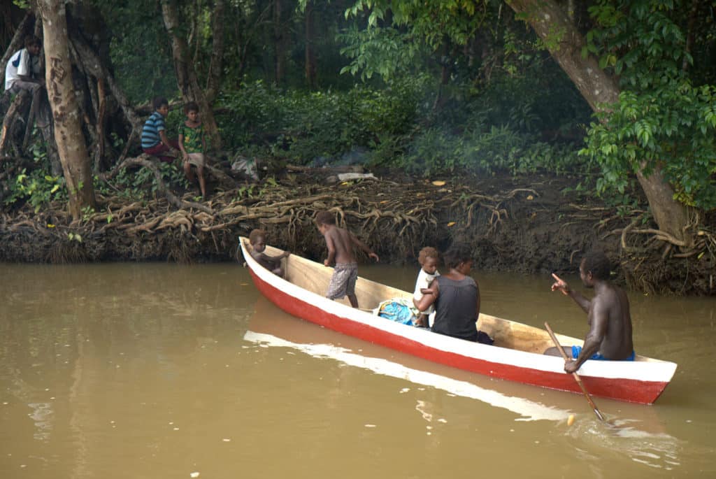 Tribal family on a riverbank
