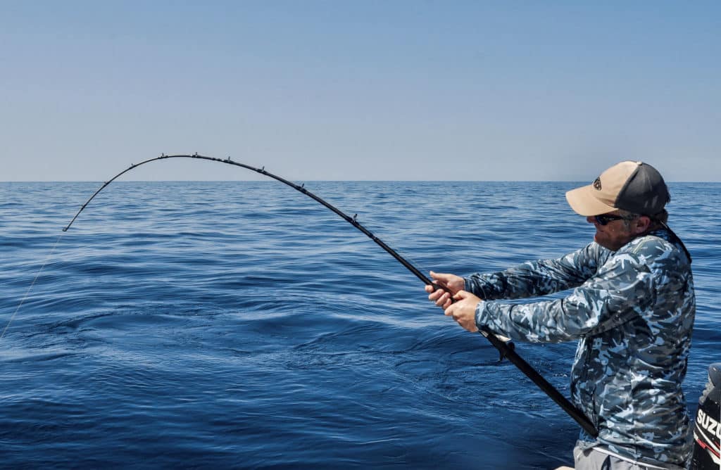 Rod bending under the pressure of fighting fish