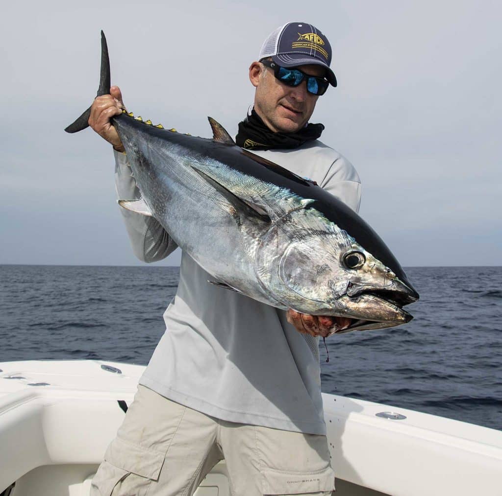 Holding up a tuna