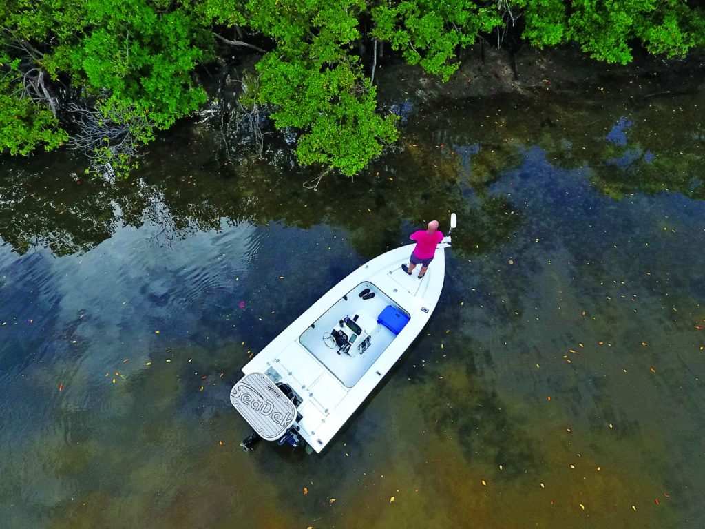 Drones and fishing - looking down at angler working mangroves