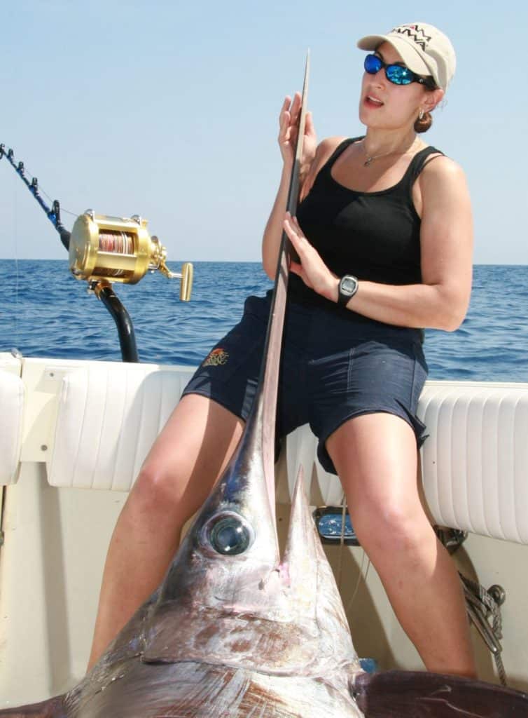 A swordfish angler lifts the head of a Gulf of Mexico 365-pounder.