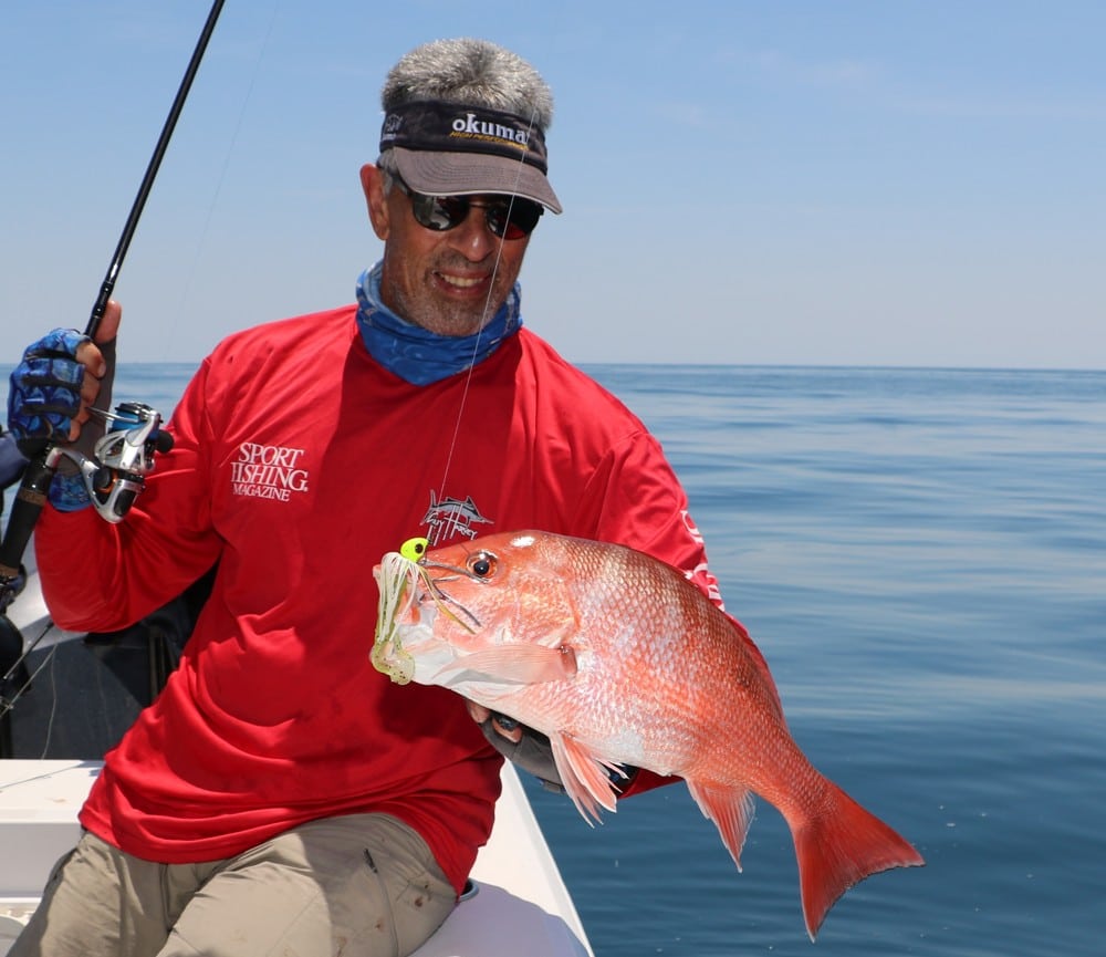 Angler holds red snapper caught saltwater fishing