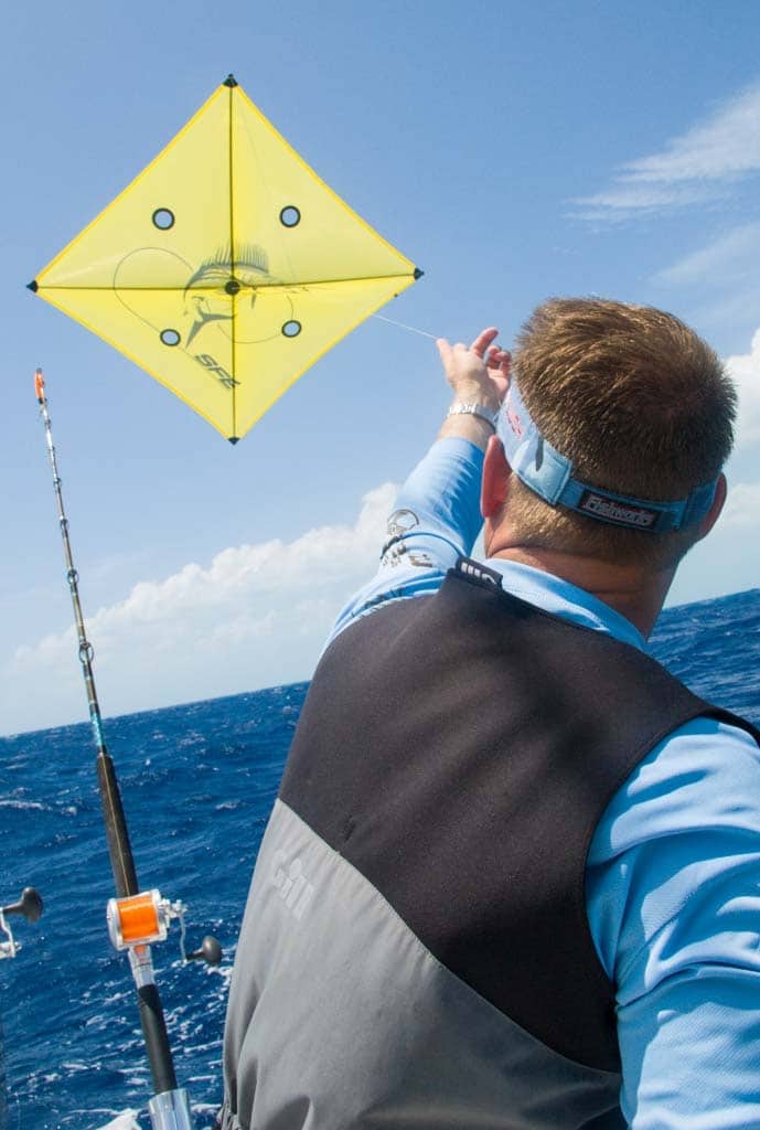 Angler releases a fishing kite offshore