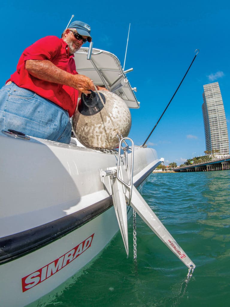 Fisherman retrieving a fishing boat anchor