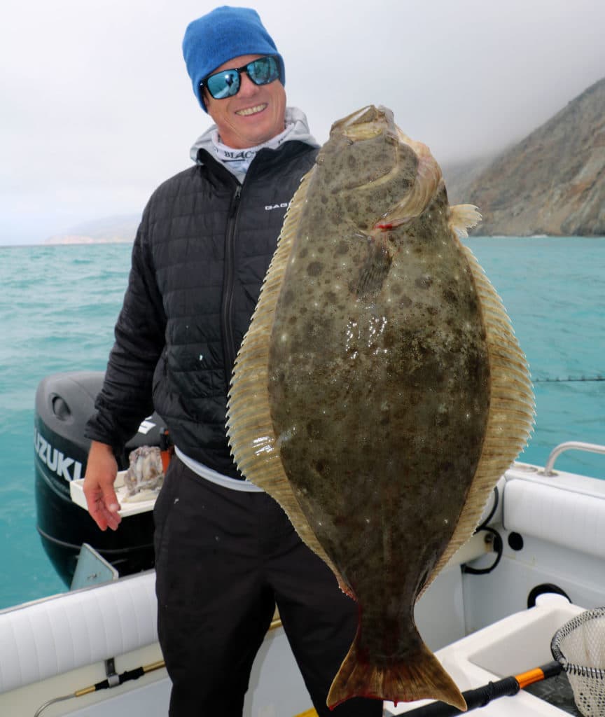 Angler holding up halibut