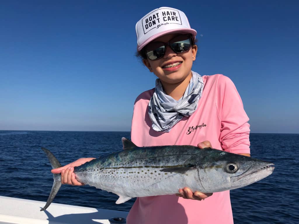 Kid holding up a mackerel