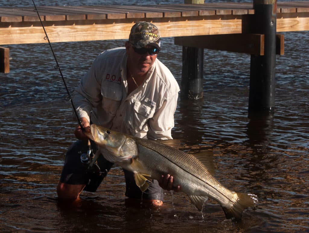 Angler holding snook