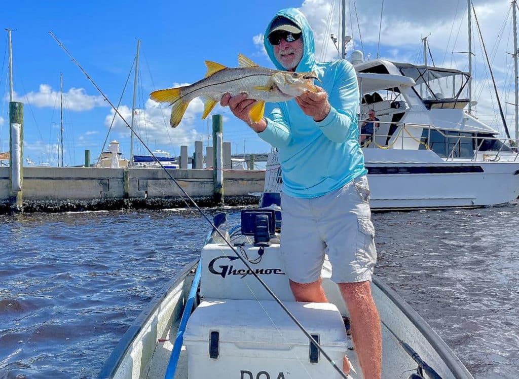 Fisherman holding up snook