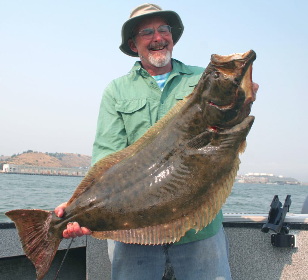 Holding up a large halibut