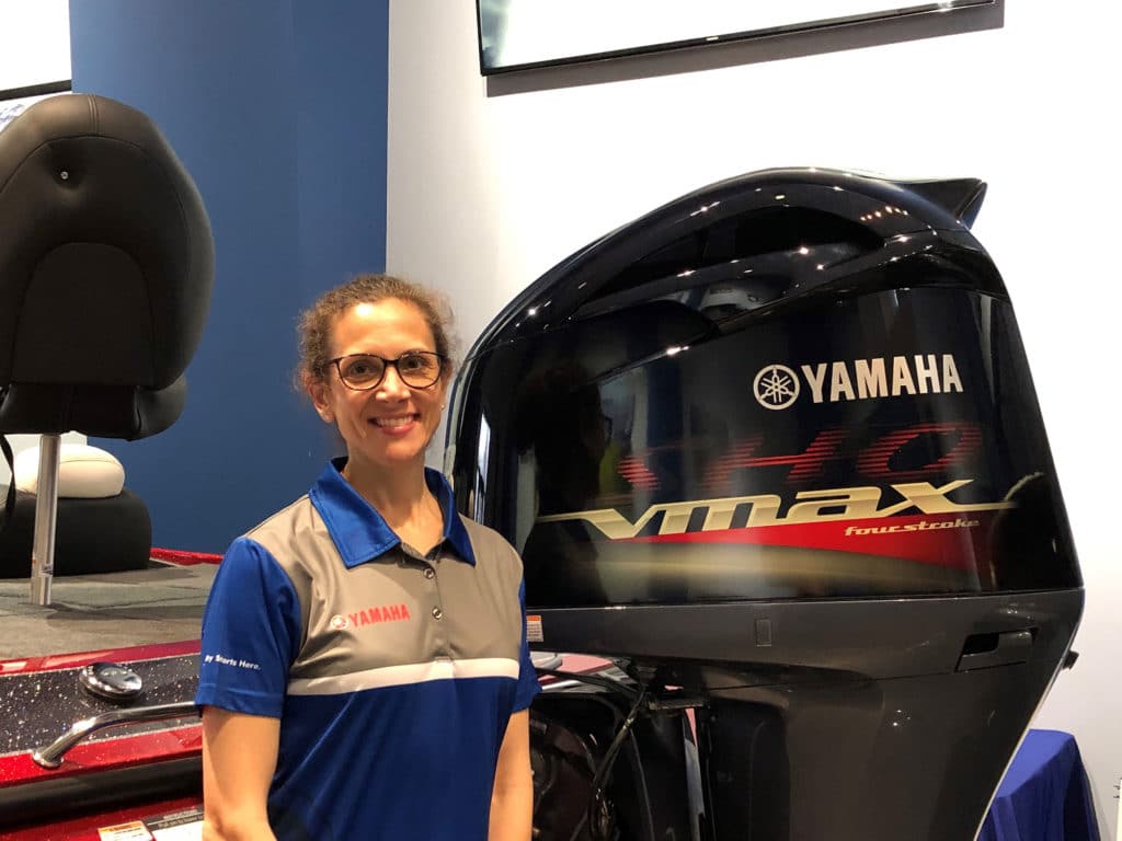 Lucy Berg standing next to Yamaha outboard