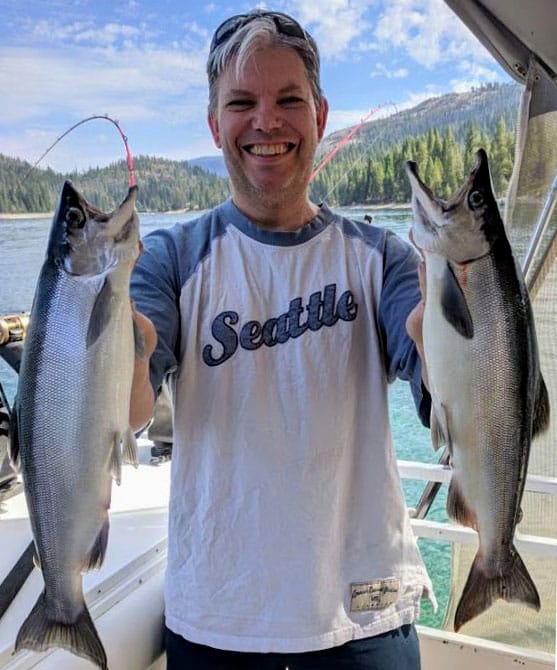 Angler holding two salmon