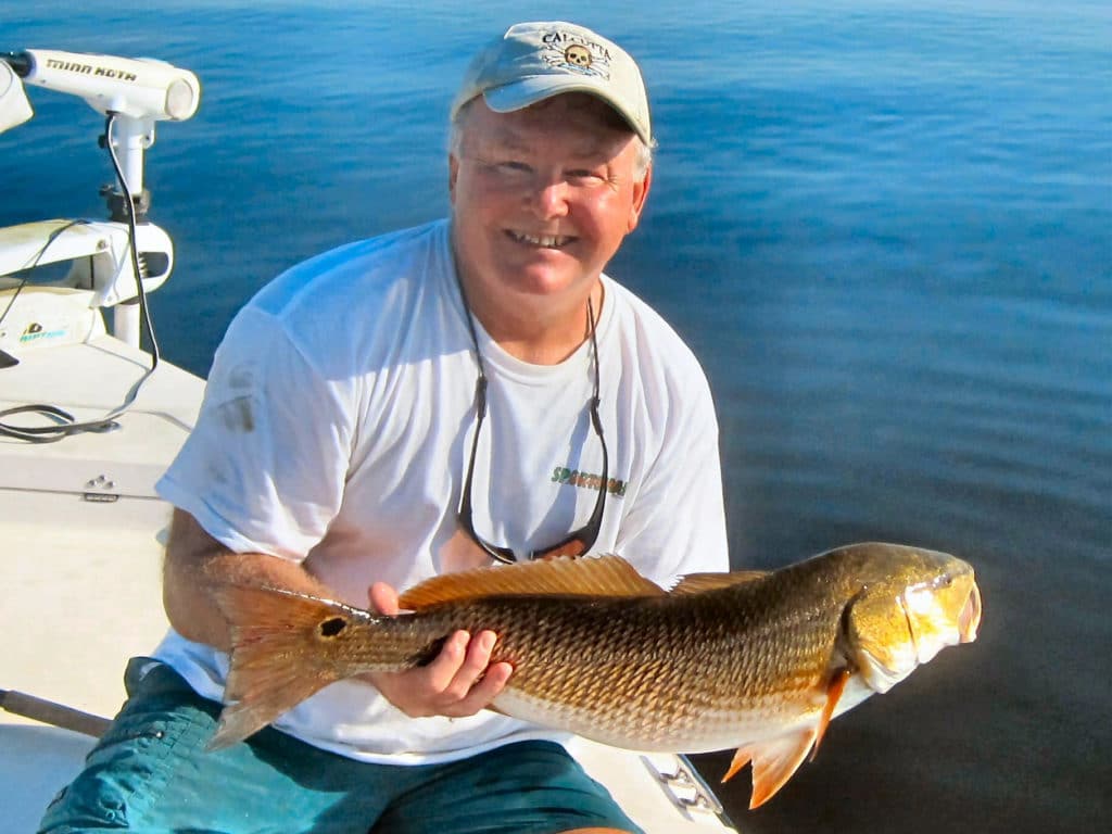 Angler holding redfish