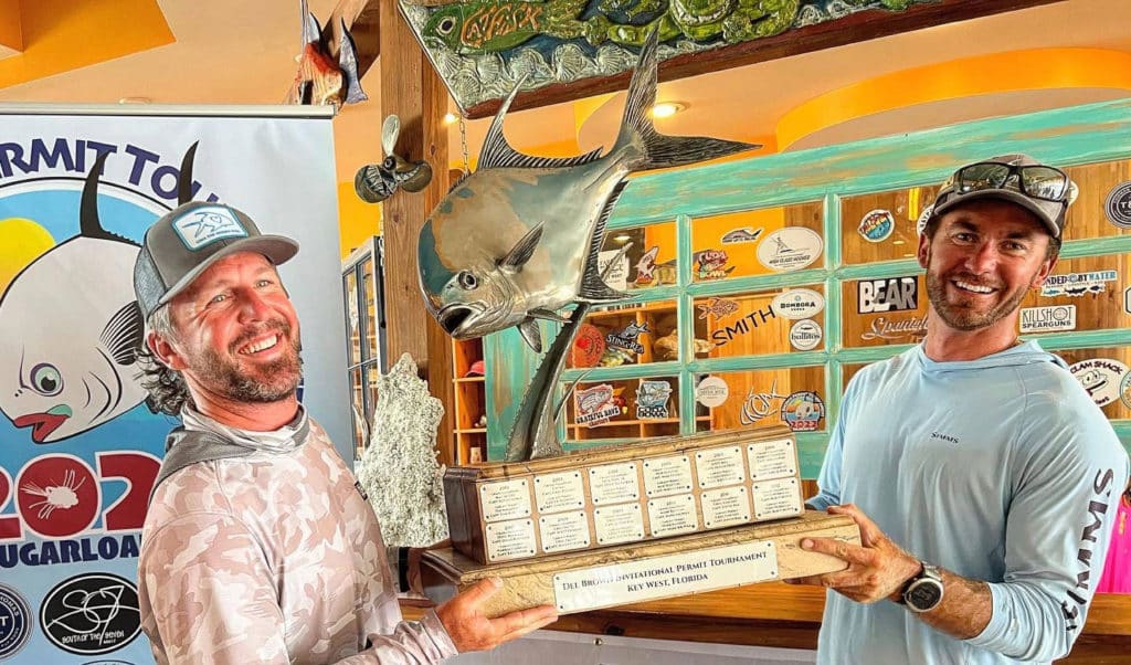 Mike Ward and Brandon Cyr hoisting trophy