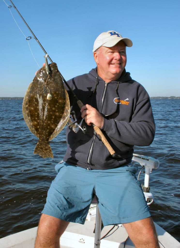Angler holding a flounder