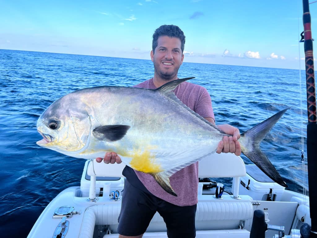 Angler with giant permit