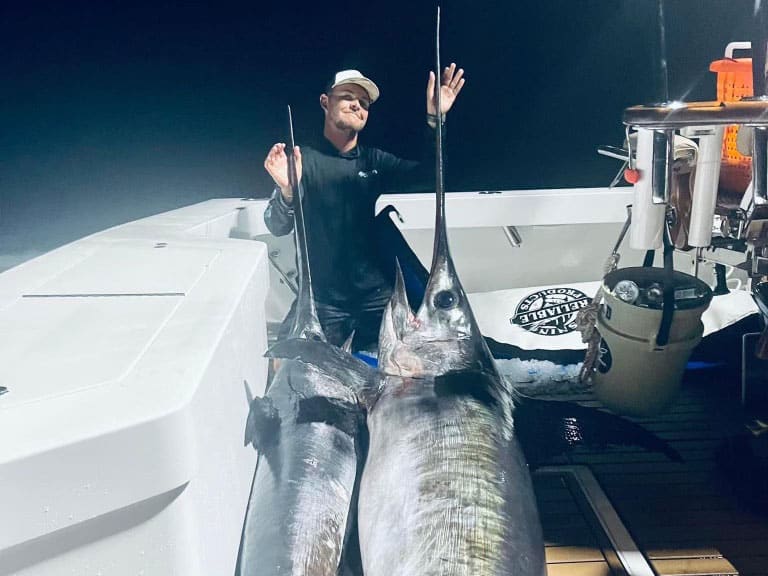 Daniel Ames with two swordfish