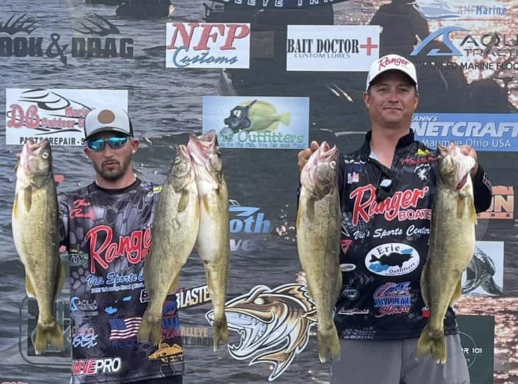 Anglers holding up walleye