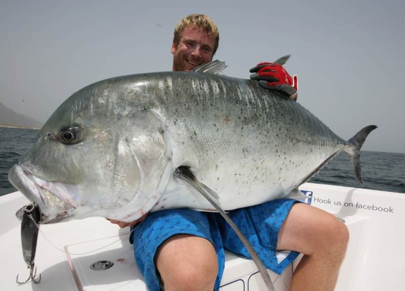 OMAN Angler with a huge giant trevally caught fishing in Oman