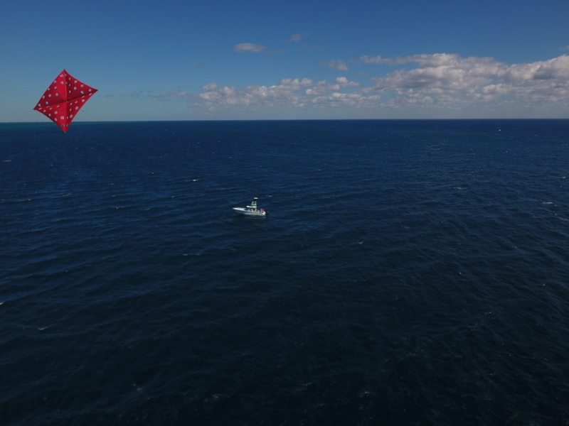 Drones and fishing - view of kite and sailfishing boat