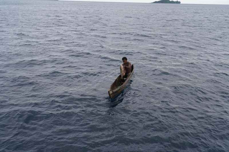 Local tribesman with an emperor fish