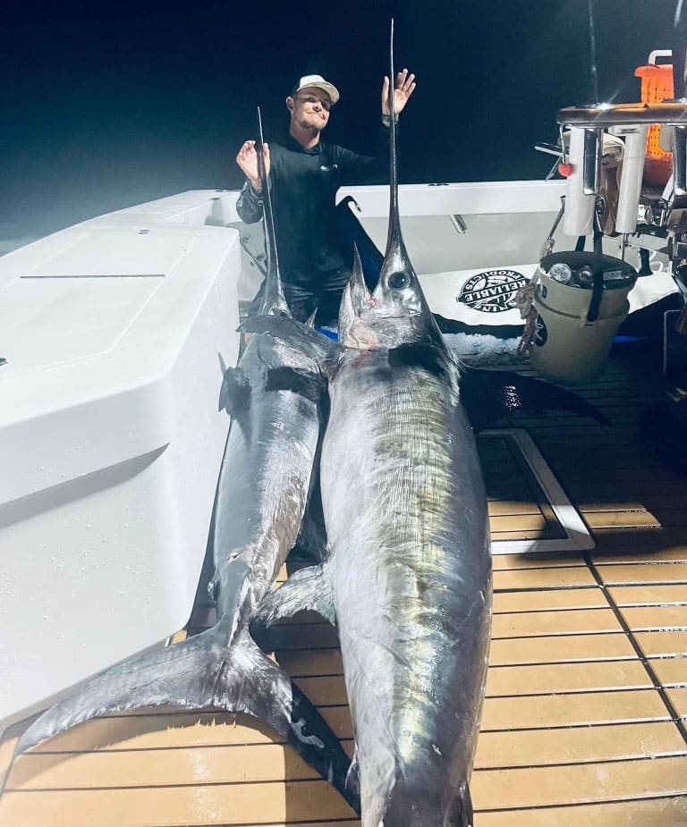 Daniel Ames with two swordfish