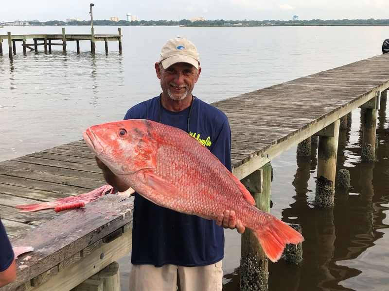 SPF1022-La-Snapper Angler holding red snapper