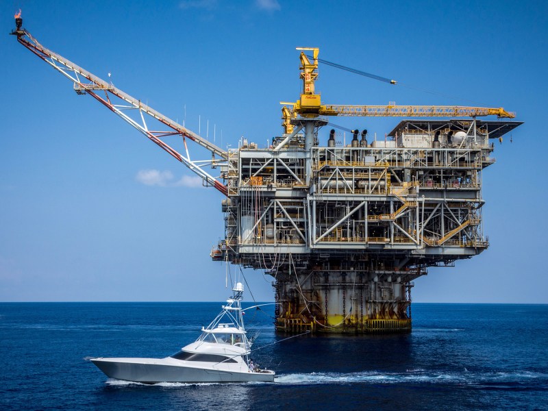 sportfisher-texas-oil-rig A sportfishing boat trolls for marlin in front of a Texas oil rig.