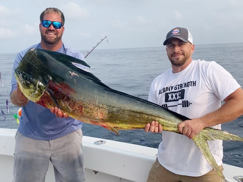 RhodeIsland-Record-Mahi1 Angler and deckhand proudly display the new Rhode Island state record mahi-mahi from the back deck of a charter boat.