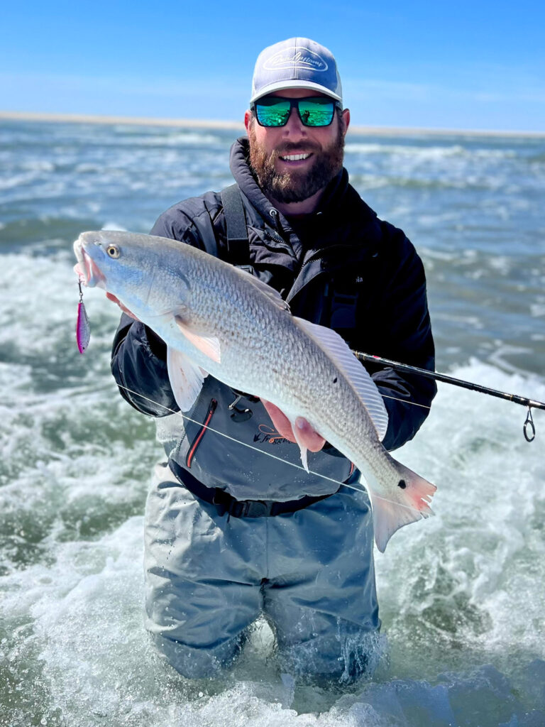 Surf fishing in waders for redfish