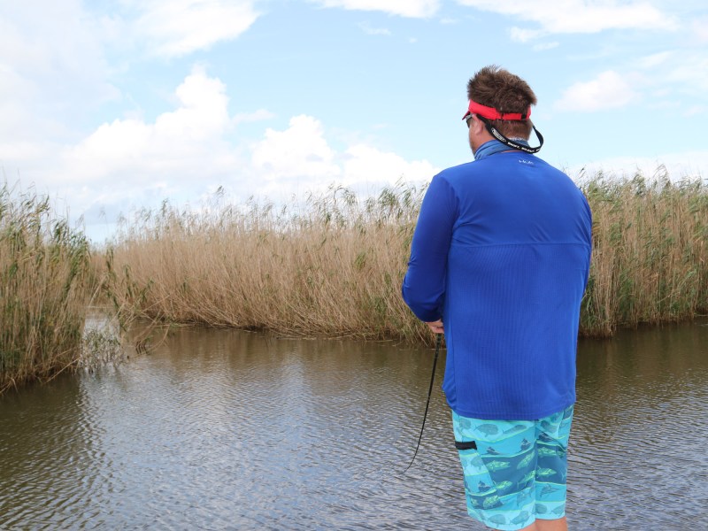 Angler fishing a marsh drain