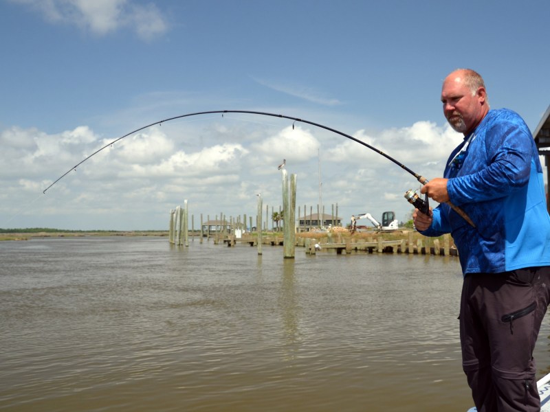 Fisherman fighting a fish.