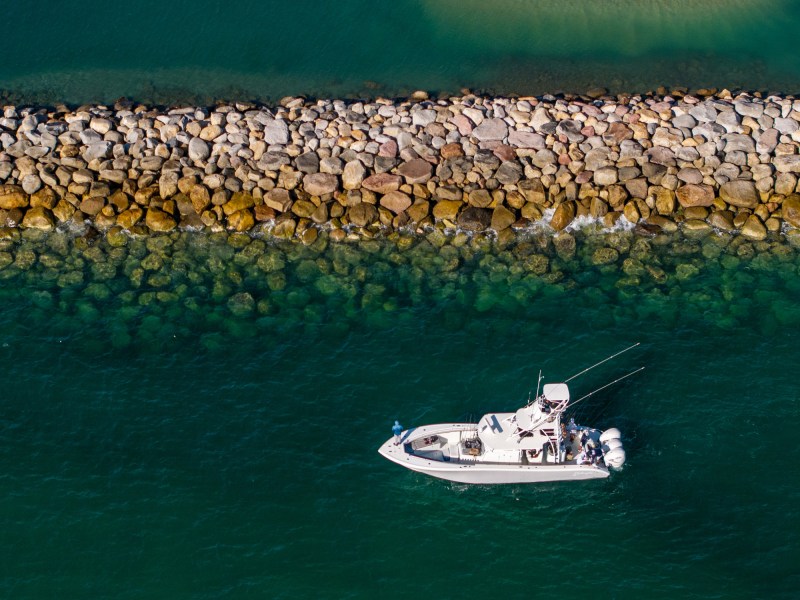 Boat fishing a jetty