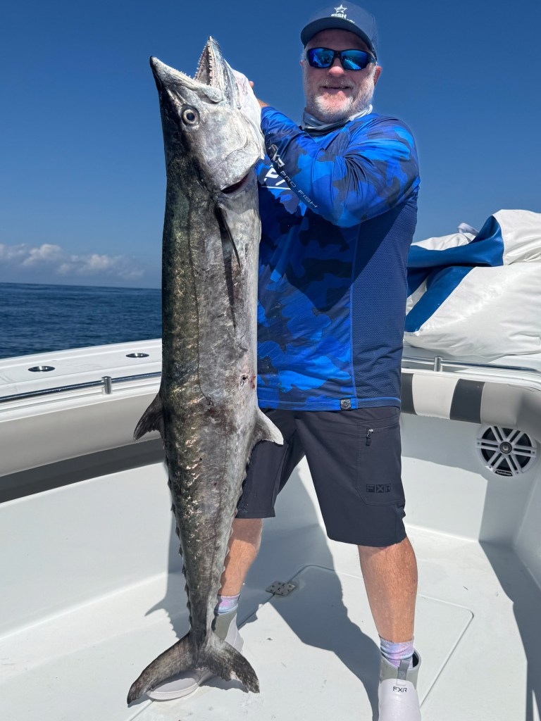 Large king mackerel and angler